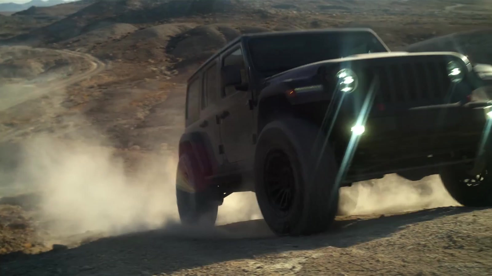 Off-road vehicle driving through dust in a commercial film